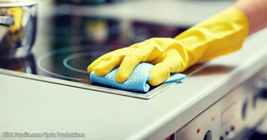 close up of woman cleaning cooker at home kitchen