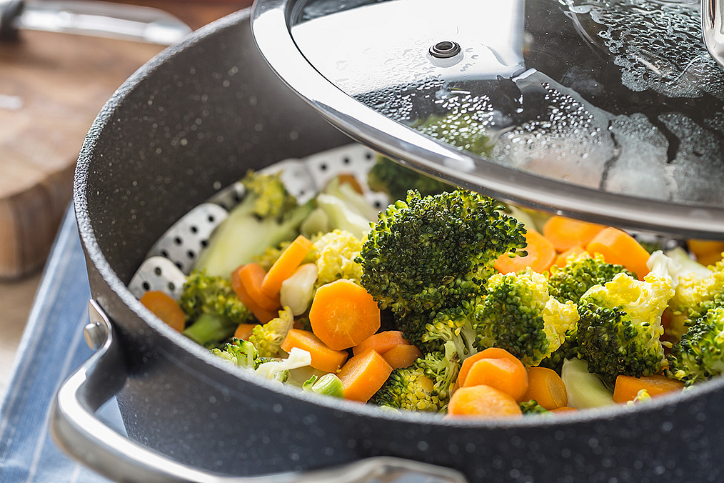 Steamed mixed vegetable in black pot. Healthy vegetable concept