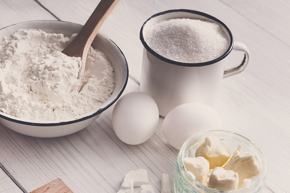 Baking ingredients on rustic white background