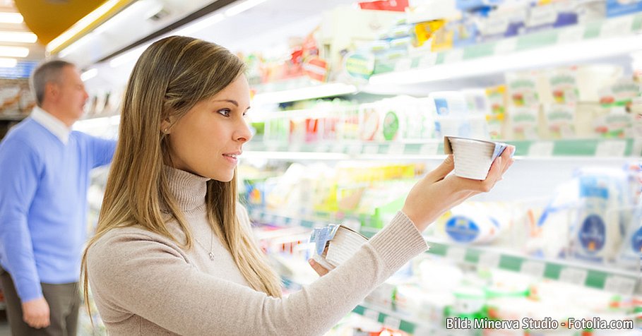 Woman taking a product in a supermarket