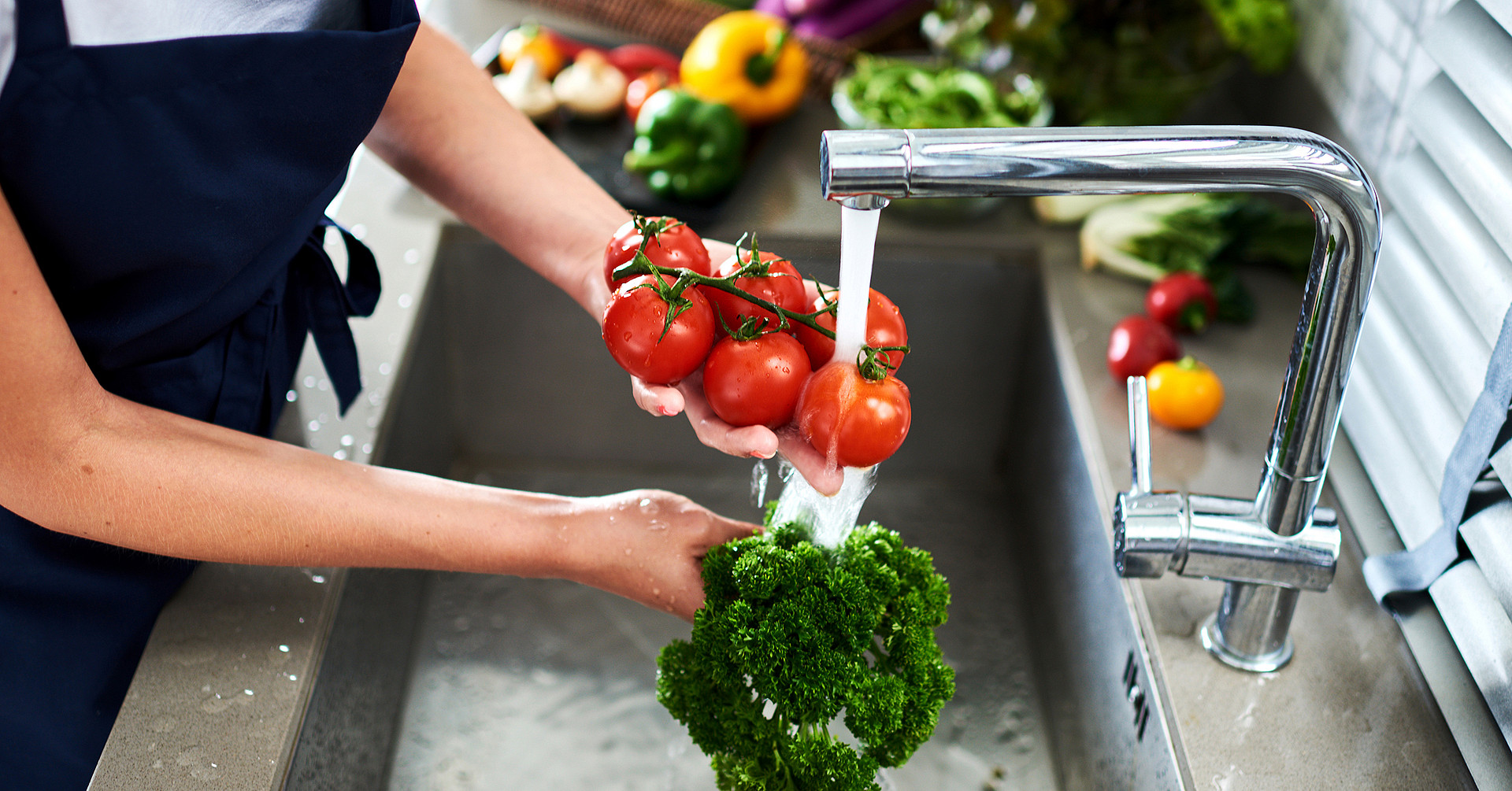 Hands woman washing vegetables. Preparation of fresh salad.