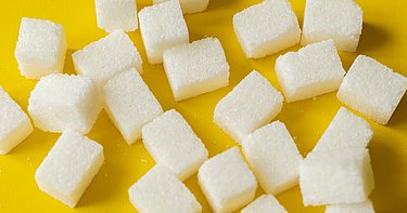 sugar cube on yellow background isolated design mockup