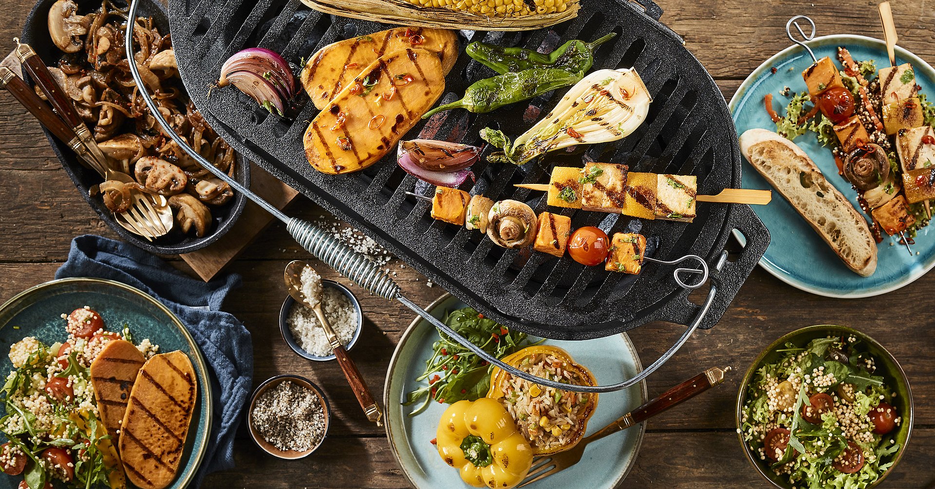 Vegetarian barbecue grilled dishes on timber table