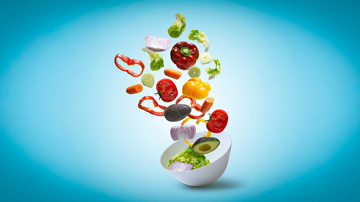 Frisches Gemüse, fällt in weiße Schüssel, Salatzutaten, schweben, heller blauer Hintergrund
