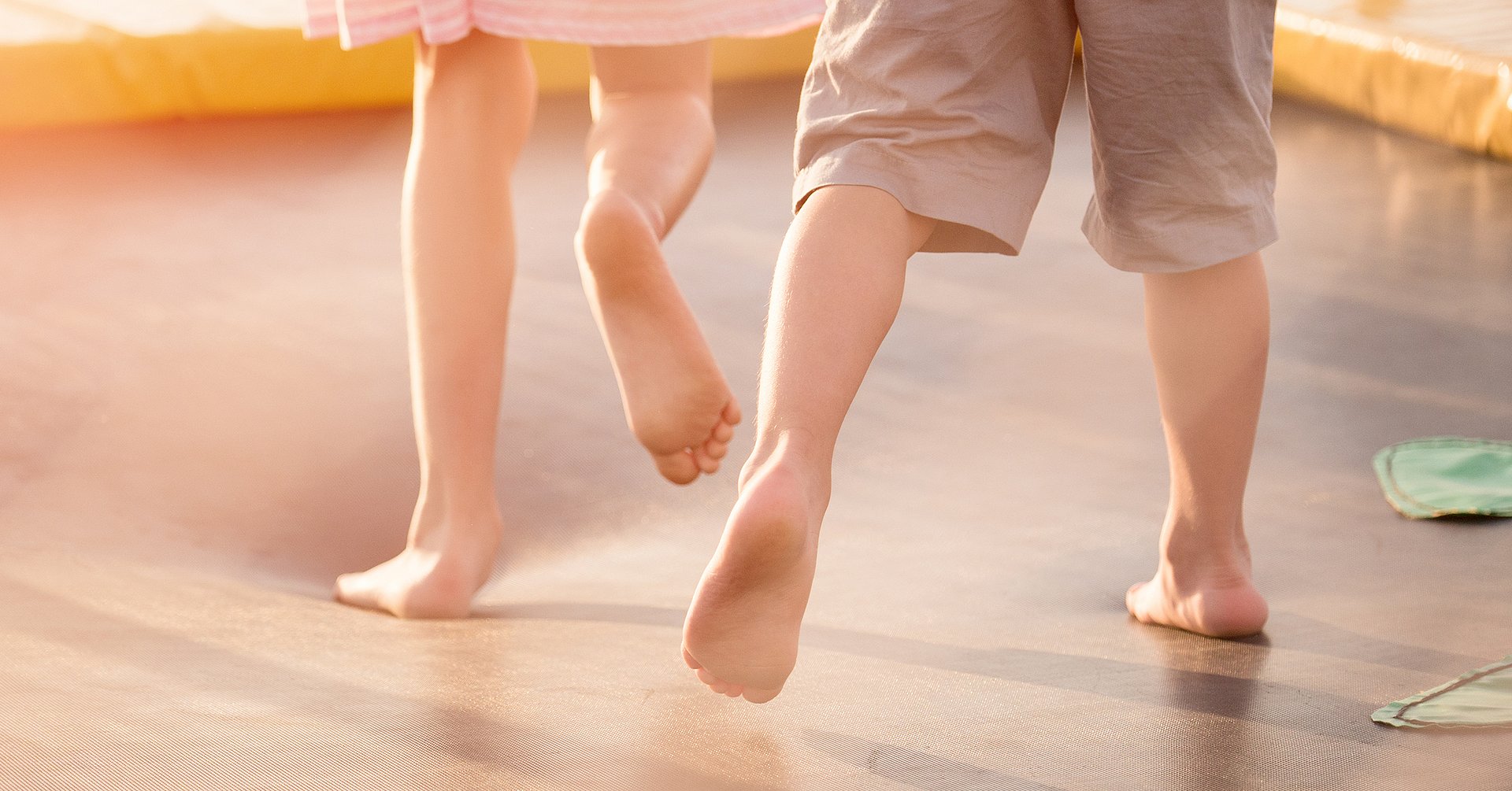 children's legs running on the trampoline