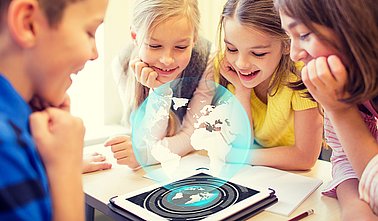 group of school kids with tablet pc in classroom