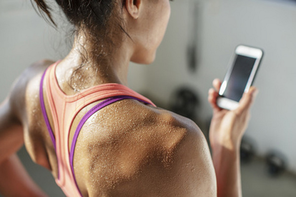 Close-up of female athlete using mobile phone in gym