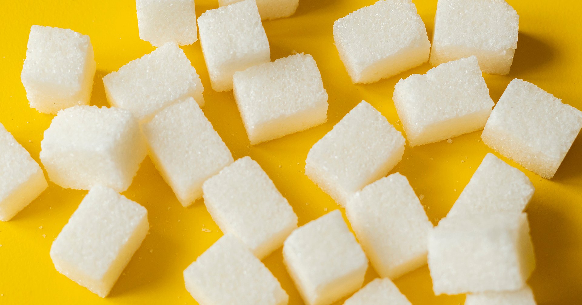 sugar cube on yellow background isolated design mockup