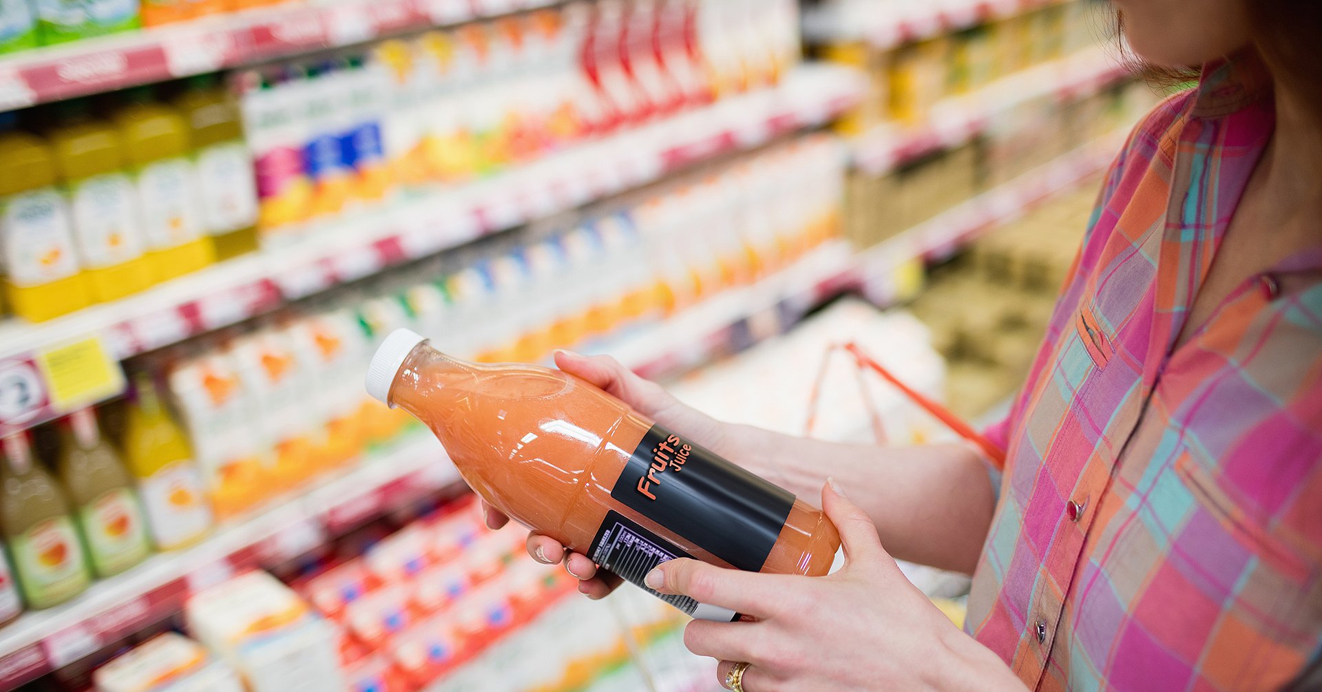 Close up view of woman choosing a bottle of fruits juice